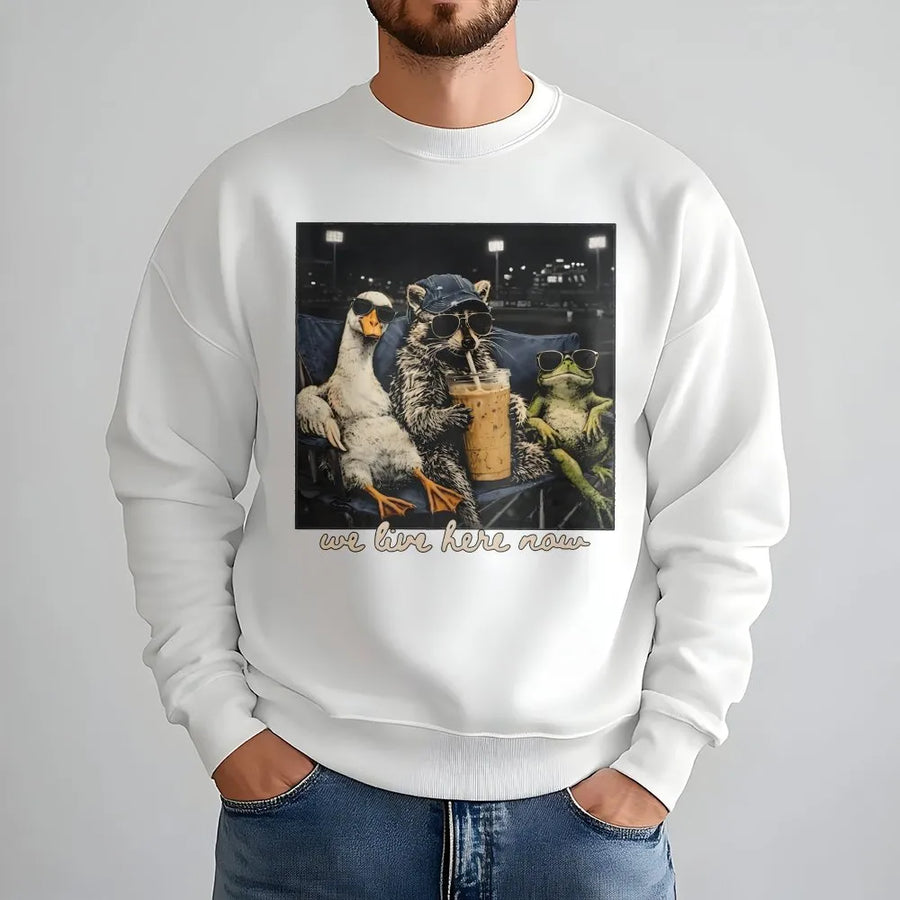 We Live Here Now Sweatshirt | Funny Goose Raccoon Frog Graphic | Soft Unisex Crewneck | Gift for Baseball Mom, Ballfield Life Apparel