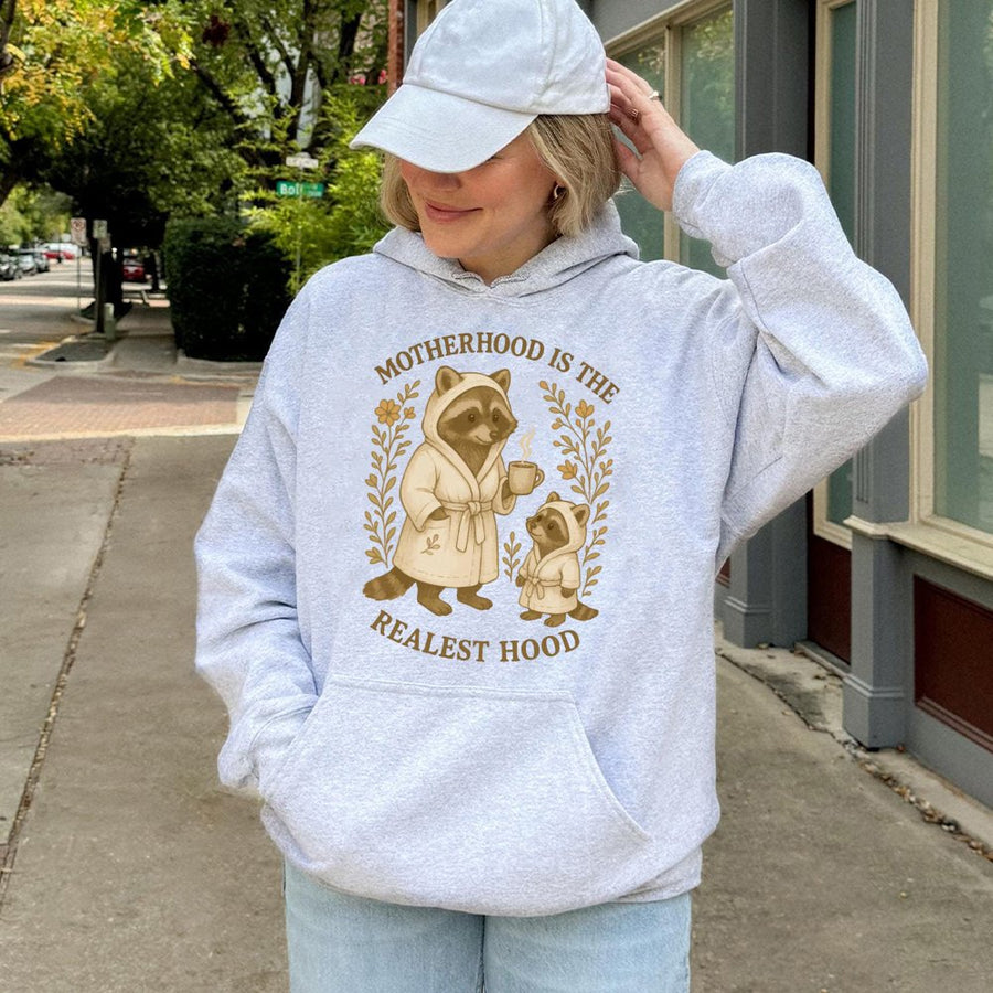 Motherhood Is The Realest Hood Hoodie | Cute Raccoon Mom Design | Premium Cotton Blend | Funny Mother's Day 2026 Gift For New Mom