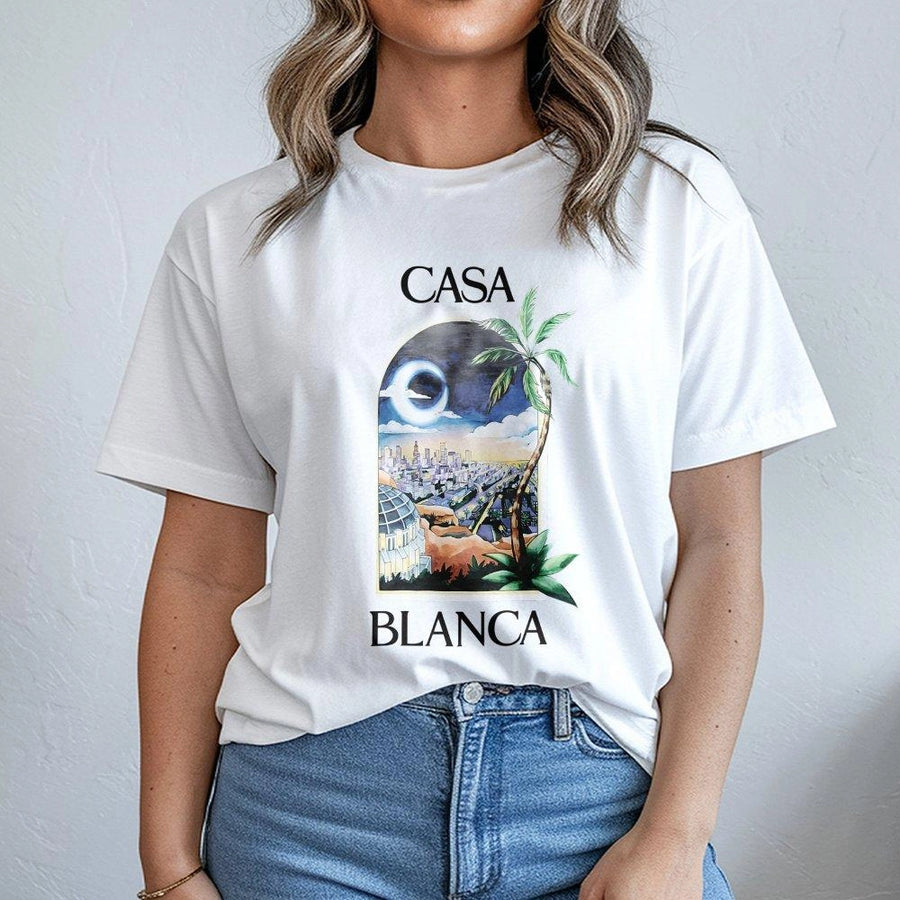 Casa Blanca Graphic T-Shirt | Retro City Palm Tree Sunset Illustration | Premium Soft Cotton | Unisex Vacation Travel Summer Streetwear Gift