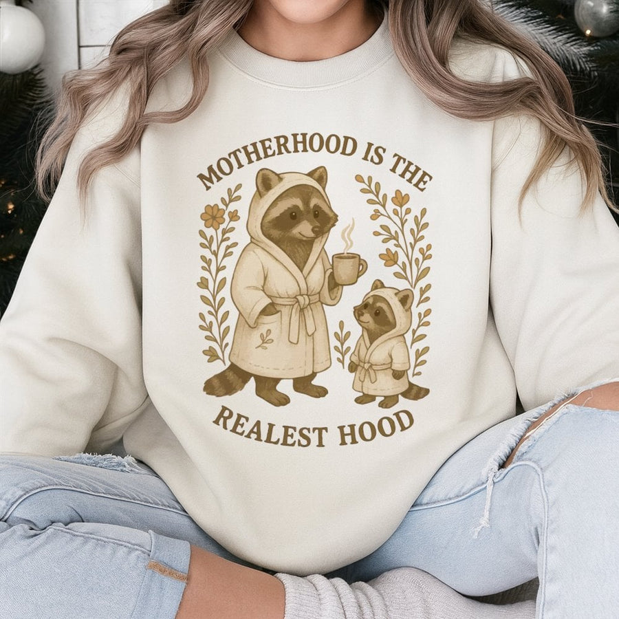 Motherhood Is The Realest Hood Sweatshirt | Funny Raccoon Mom Graphic | Soft Cotton Blend Unisex Pullover | Unique Mother's Day 2026 Gift For New Mom