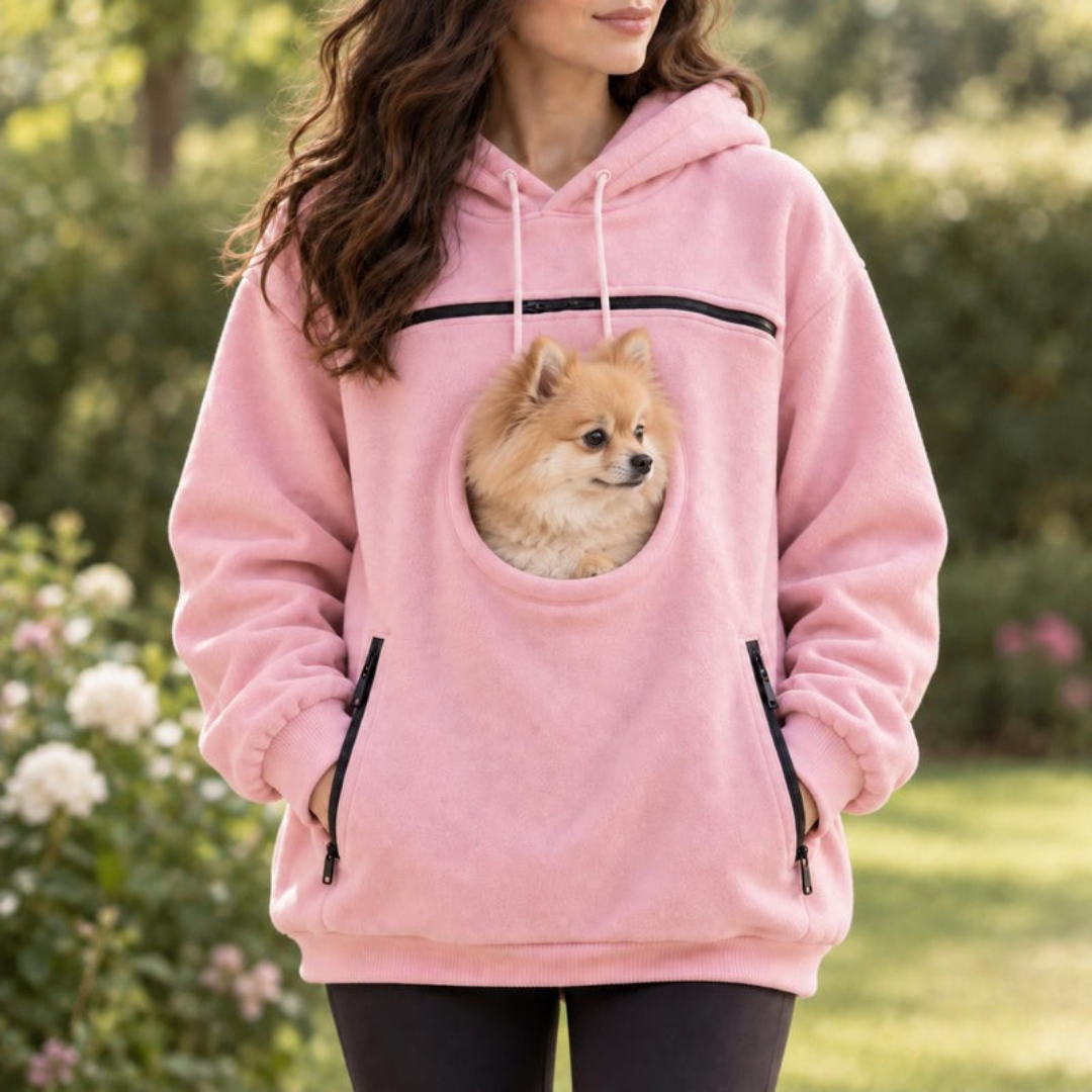Pink pet carrier hoodie outdoors, small dog in the front pouch