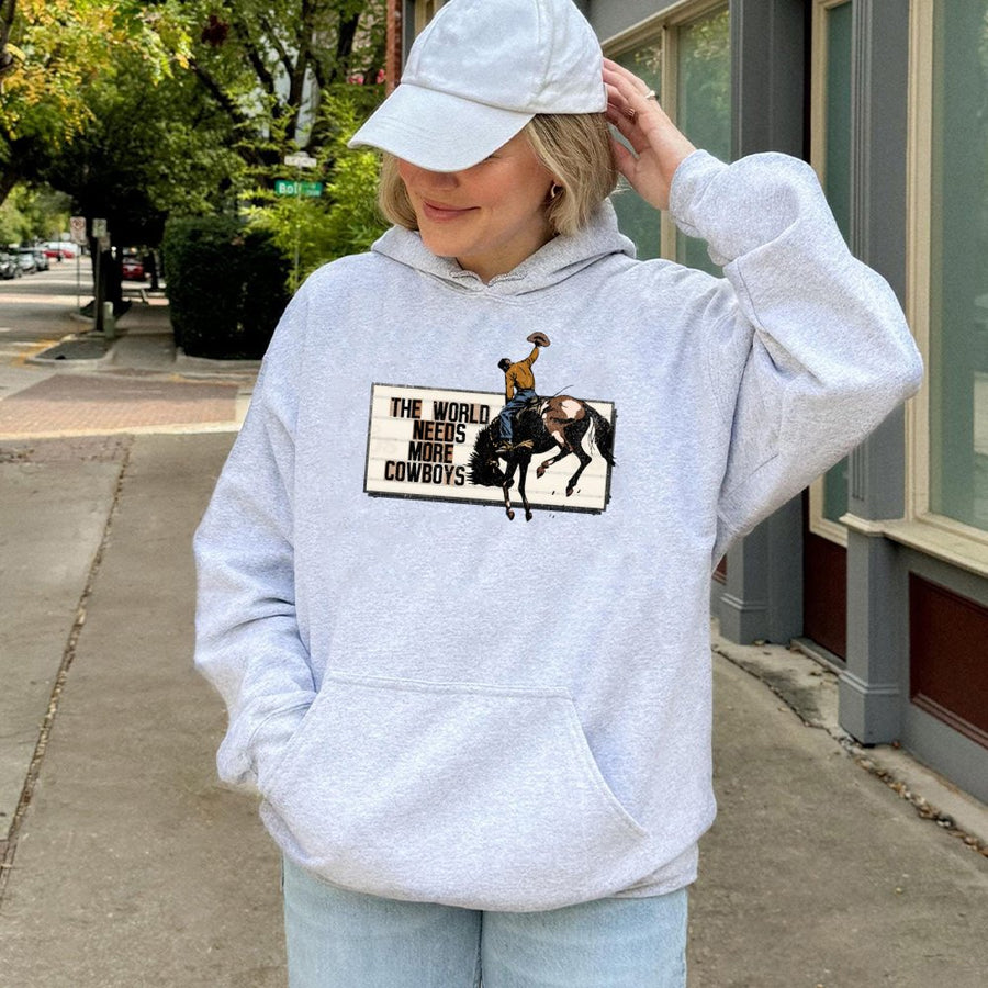 The World Needs More Cowboys Hoodie | Vintage Rodeo Graphic Western Sweatshirt | Premium Cotton Blend | Gift for Country Music Lovers & Ranchers