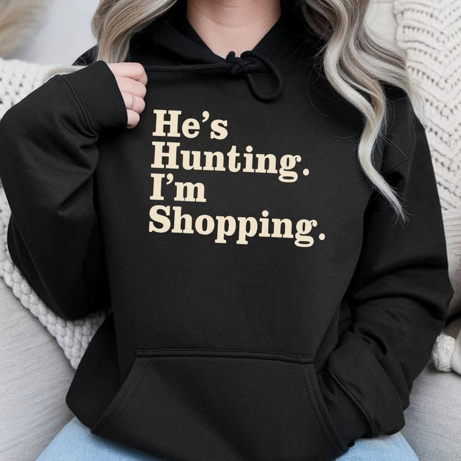 He's Hunting I'm Shopping Hoodie | Funny Country Life Graphic Sweatshirt | Premium Cotton Blend Apparel | Gift for Hunter Wife Girlfriend