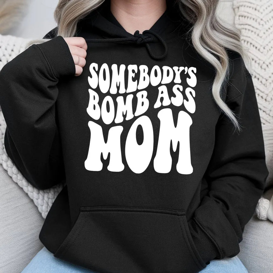 Somebody's Bomb Ass Mom Hoodie | Retro Wavy Typography Graphic | Soft Cotton-Polyester Blend | Trendy Mother's Day 2026 Gift For New Moms