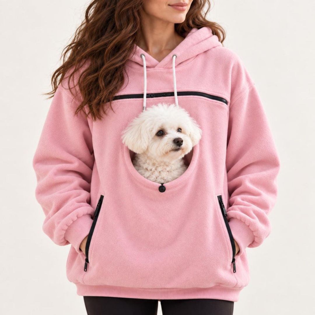 Pink pet carrier hoodie, white dog in the front pouch