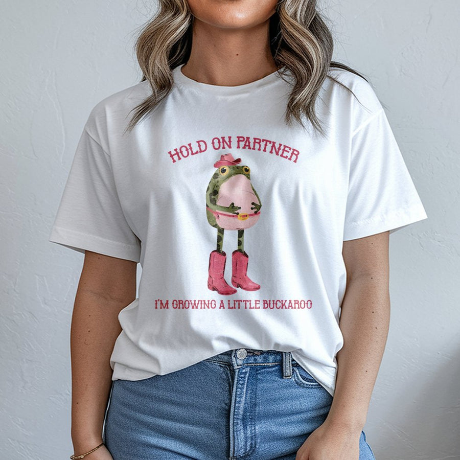 Hold On Partner Frog T-Shirt | Funny Western Pregnancy Announcement Graphic | Premium Soft Cotton | Cute Gift for Expecting Mom & Cowboy Lovers