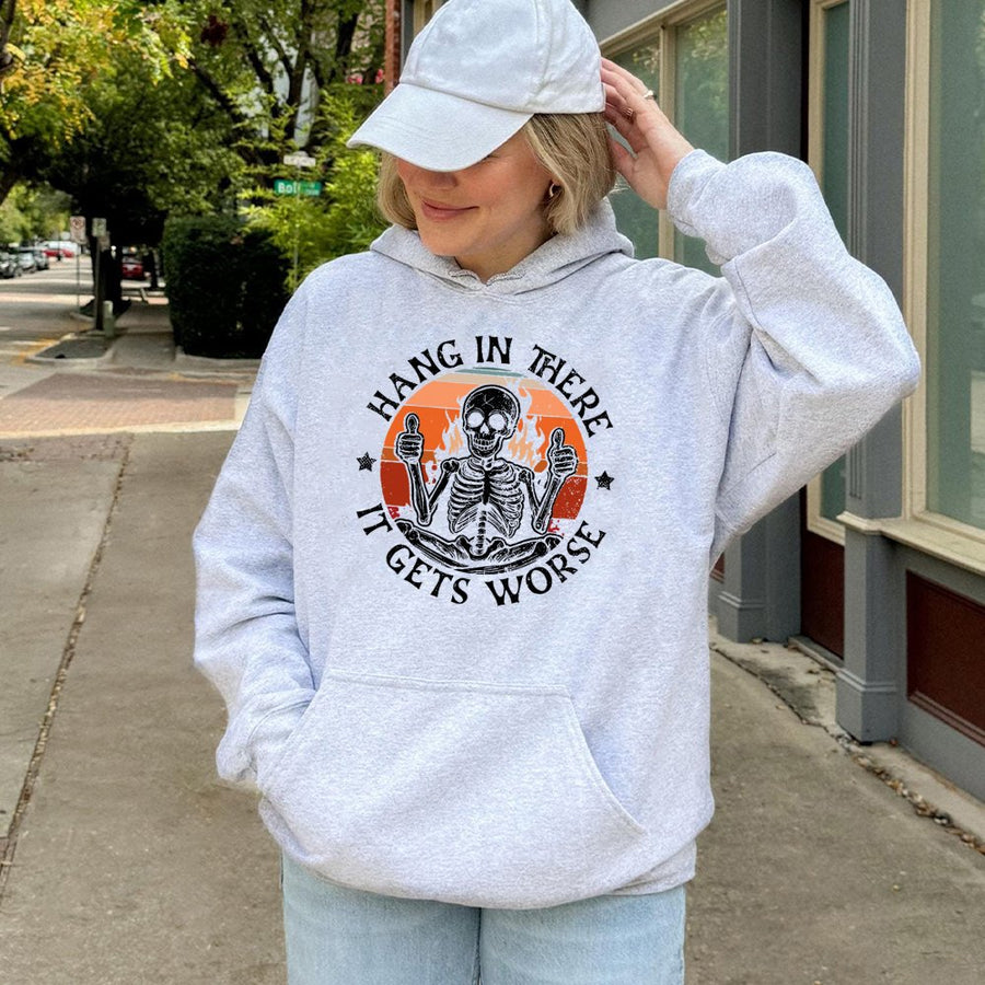 Hang In There It Gets Worse Skeleton Hoodie | Retro Sarcastic Graphic Pullover | Premium Cotton-Blend Comfort | Unisex Gift for Dark Humor Lovers