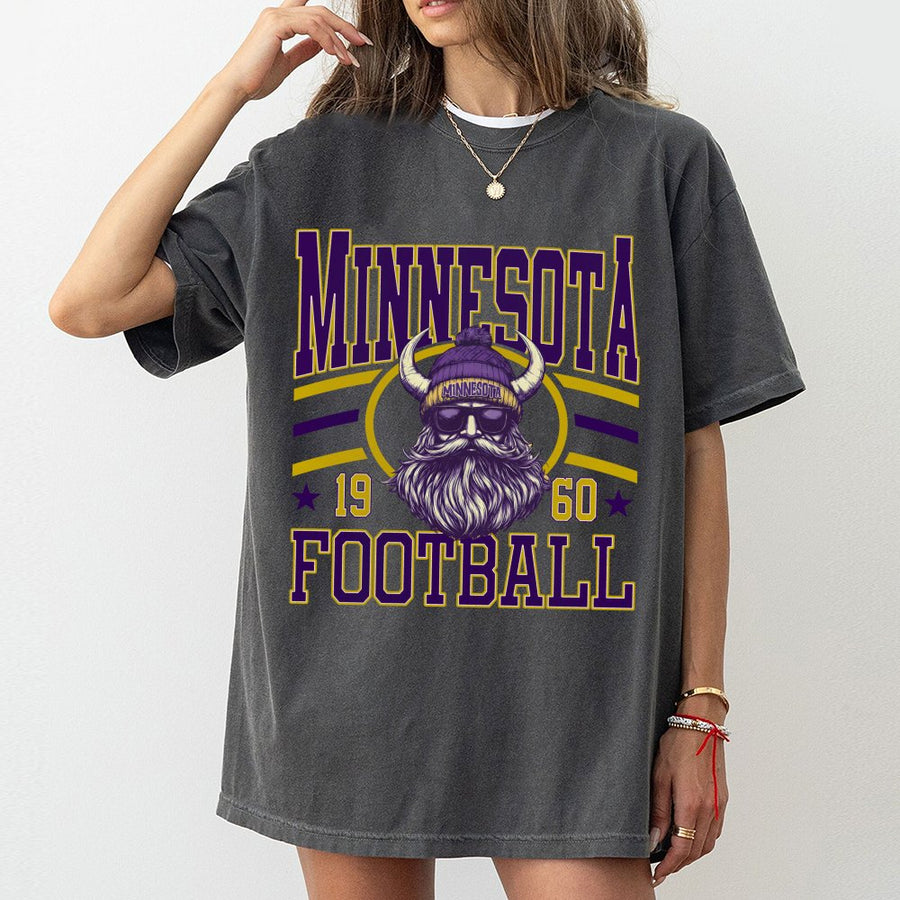 Minnesota β
19 60 β
Football Featuring A Viking Mascot With A Long Beard Wearing A Purple Horned Beanie And Sunglasses T-Shirt