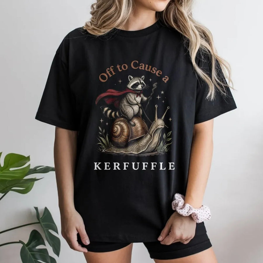 Off To Cause A Kerfuffle T-Shirt | Whimsical Raccoon Riding Snail Graphic | 100% Cotton Premium Tee | Funny Animal Nature Lover Gift For Adults
