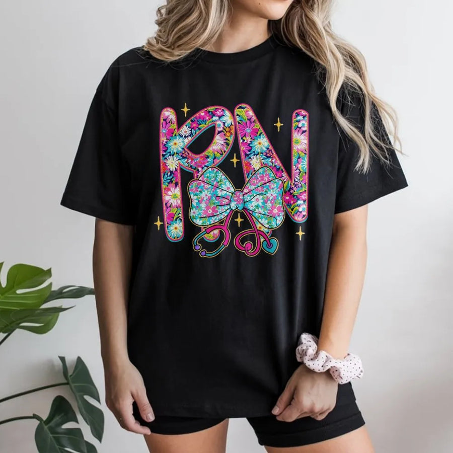 RN Nurse T-Shirt | Floral Stethoscope Bow Graphic Design | Premium Cotton Apparel | Perfect Graduation Gift for Nursing Students and Registered Nurses
