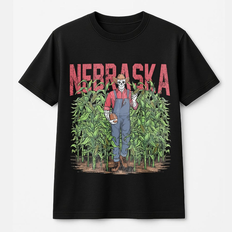 Nebraska With A Skeleton Dressed As A Farmer In Overalls Holding A Football And An Ear Of Corn While Standing In A Cornfield T-Shirt