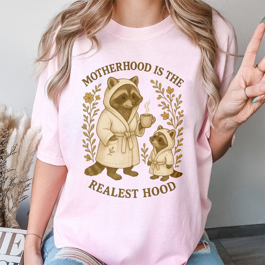 Motherhood Is The Realest Hood T-Shirt | Cute Raccoon Mom and Baby Graphic | Premium 100% Cotton Tee | Funny Mother's Day 2026 Gift for New Mom