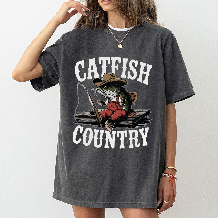 Catfish Country Fishing T-Shirt | Funny Cowboy Catfish Cartoon Graphic | 100% Cotton Premium Tee | Unique Angler Gift for Men and Women