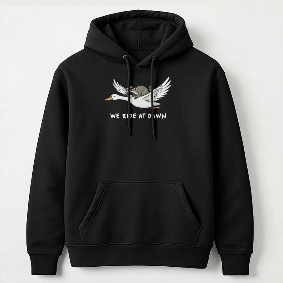We Ride At Dawn Hoodie | Funny Raccoon Riding Goose Graphic | Premium Cotton Blend Pullover | Cute Animal Lover Gift For Men And Women