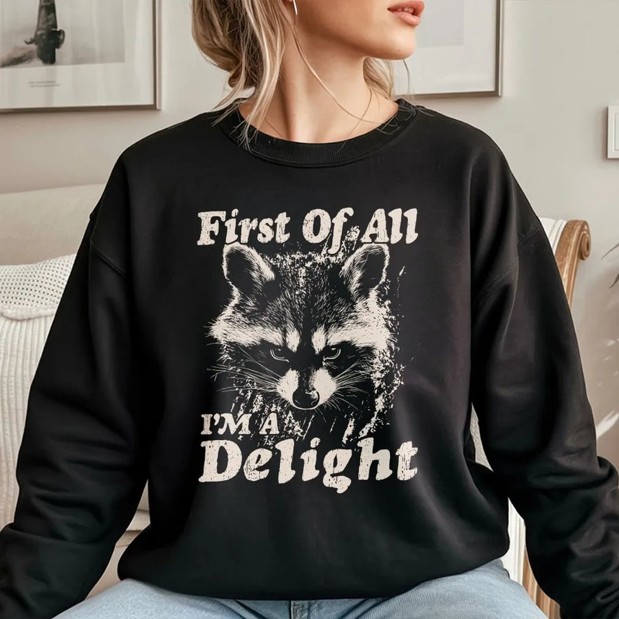 Funny Raccoon Sweatshirt | 'First Of All I'm A Delight' Graphic | Cozy Crewneck Pullover | Sarcastic Humor Gift for Raccoon Lovers