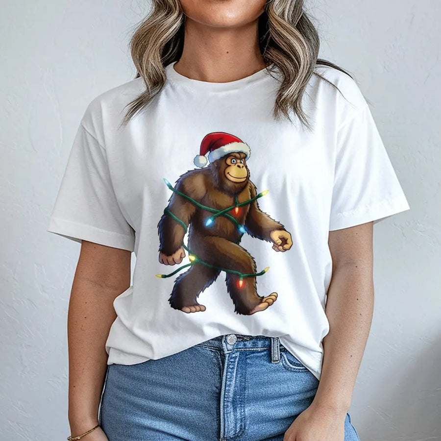 Bigfoot Christmas T-Shirt | Funny Sasquatch Wearing Santa Hat & Holiday Lights | Premium Soft Cotton Graphic Tee | Unique Xmas Gift For Him