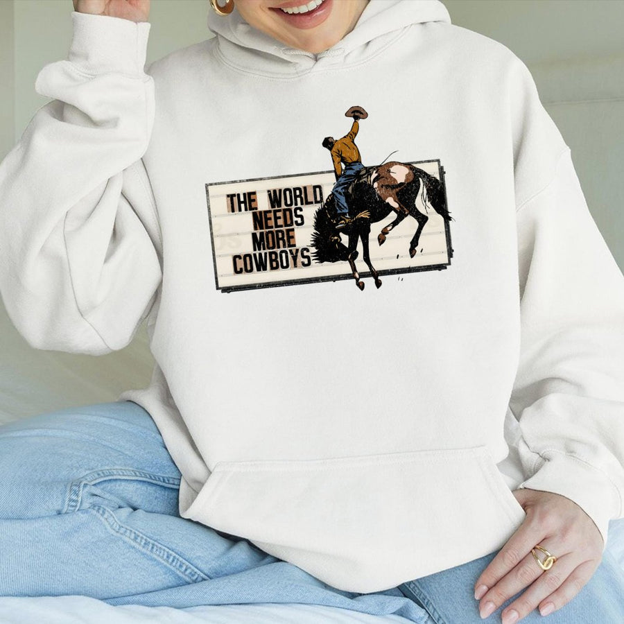 The World Needs More Cowboys Hoodie | Vintage Rodeo Graphic Western Sweatshirt | Premium Cotton Blend | Gift for Country Music Lovers & Ranchers