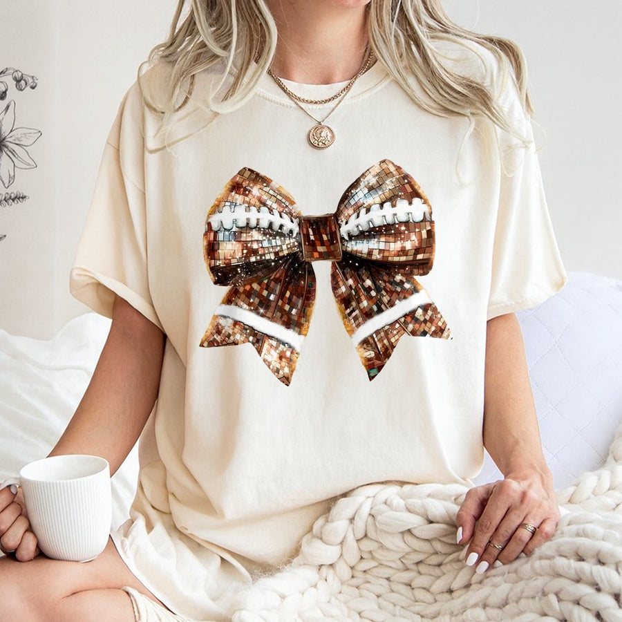 Football Disco Bow Graphic T-Shirt | Sequin Aesthetic Fall Game Day Design | Premium Soft Cotton Tee | Cute Gift for Football Moms & Fans