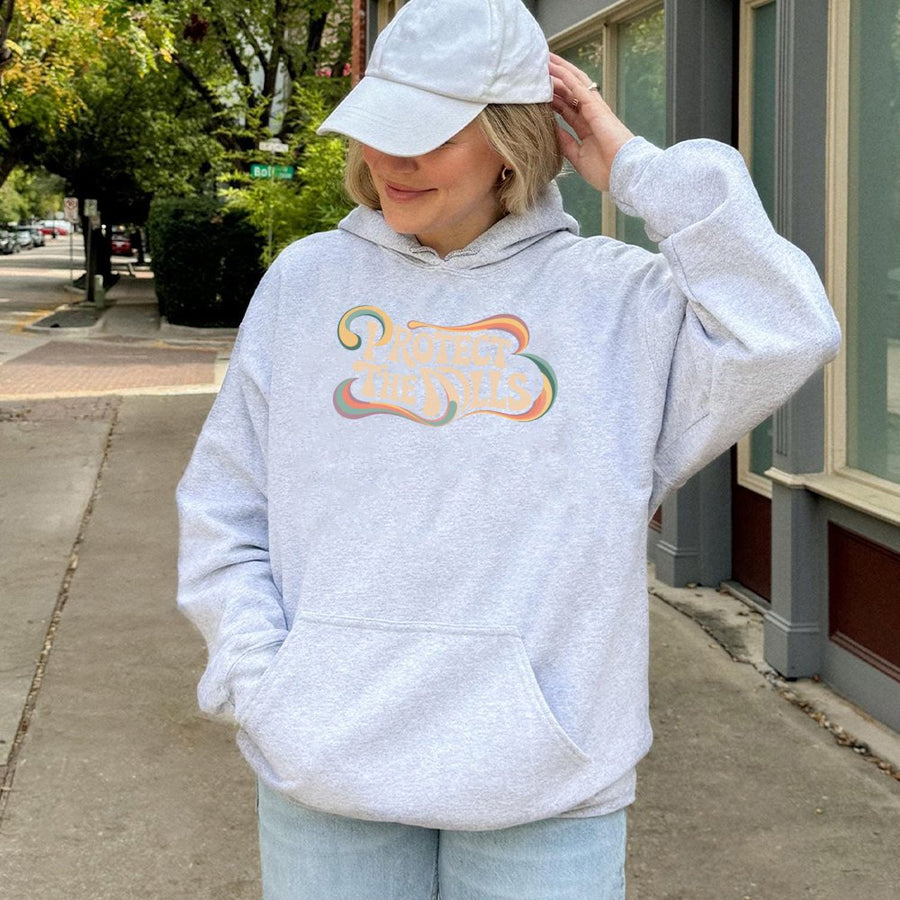 Protect The Dolls Hoodie | Retro Groovy Feminist Graphic Print | Soft Cotton-Blend Premium Apparel | Empowerment Gift For Women & Best Friends