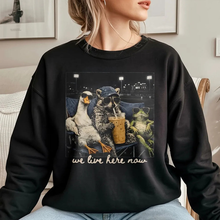 We Live Here Now Sweatshirt | Funny Goose Raccoon Frog Graphic | Soft Unisex Crewneck | Gift for Baseball Mom, Ballfield Life Apparel
