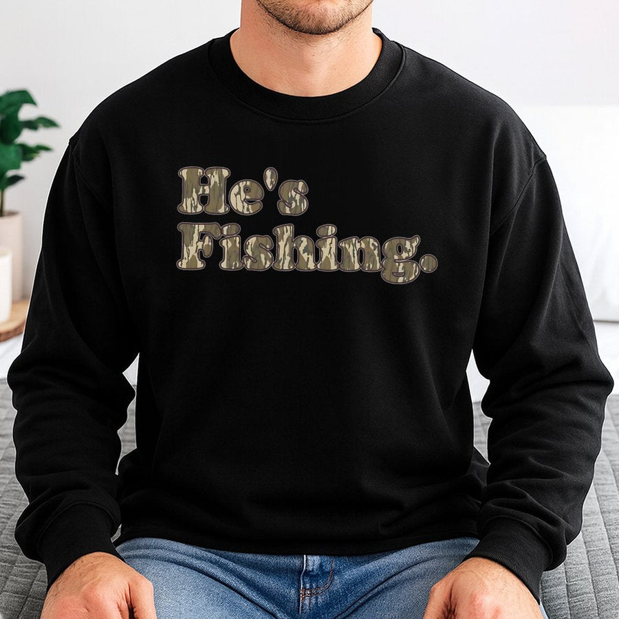 He's Fishing Sweatshirt | Camo Bottomland Typography Design | Premium Cotton Blend | Gift for Fisherman, Outdoorsman, Hunting Enthusiast