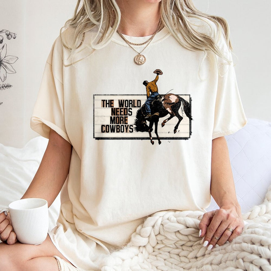 The World Needs More Cowboys T-Shirt | Retro Western Rodeo Graphic Tee | 100% Premium Cotton | Country Music & Ranch Life Gift for Adults