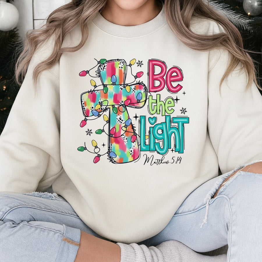 Be The Light Sweatshirt | Christmas Cross Bible Verse Design | Premium Cotton Blend | Faith-Based Holiday Gift for Women and Men
