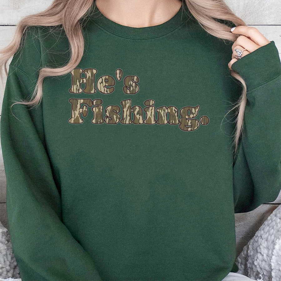 He's Fishing Sweatshirt | Camo Bottomland Typography Print | Premium Cotton Blend | Gift for Anglers and Outdoor Lovers
