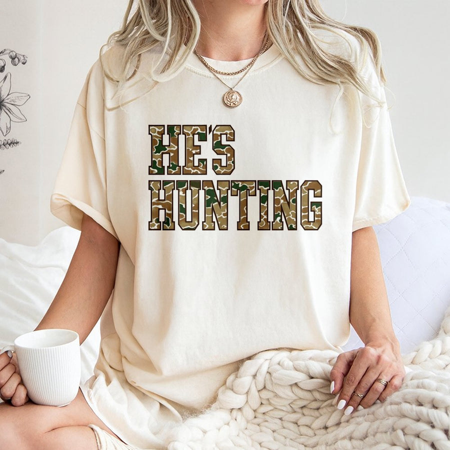 He's Hunting T-Shirt | Camo Print Varsity Lettering | 100% Cotton Premium Tee | Hunting Wife Gift for Deer Season