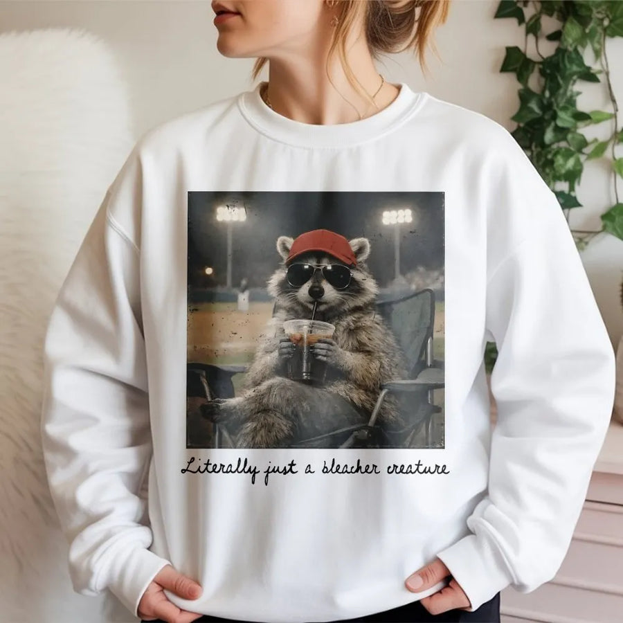 Bleacher Creature Sweatshirt | Funny Raccoon Baseball Graphic | Cozy Unisex Crewneck | Gift for Baseball Mom, Softball Fan Gift