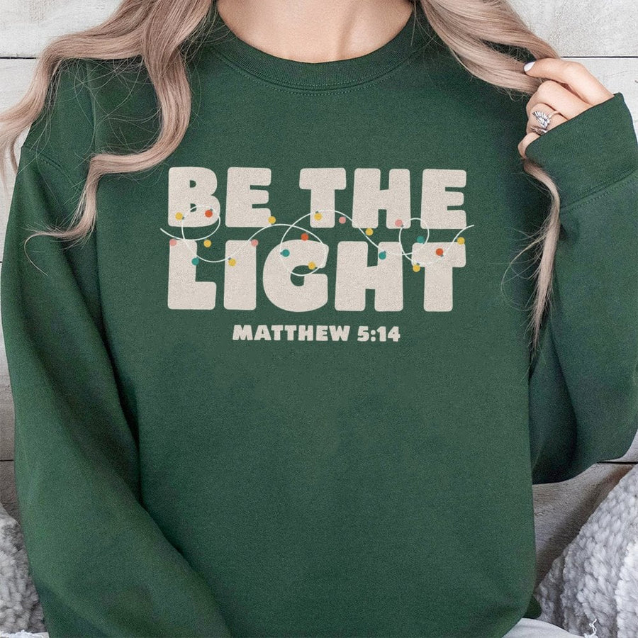 Be The Light Sweatshirt | Matthew 5:14 Christmas Bible Verse Graphic | Premium Cotton Blend | Faith-Based Religious Christian Gift for Women
