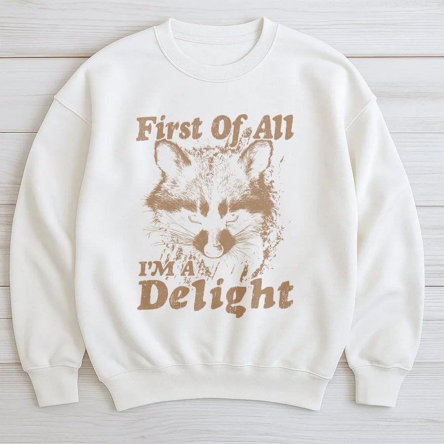 Funny Raccoon Sweatshirt | 'First Of All I'm A Delight' Graphic | Cozy Crewneck Pullover | Sarcastic Humor Gift for Raccoon Lovers