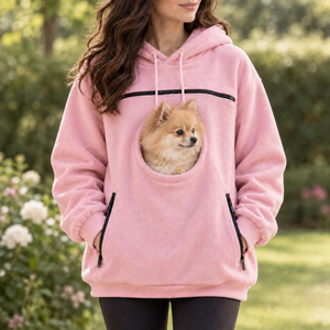 Pink pet carrier hoodie outdoors, small dog in the front pouch