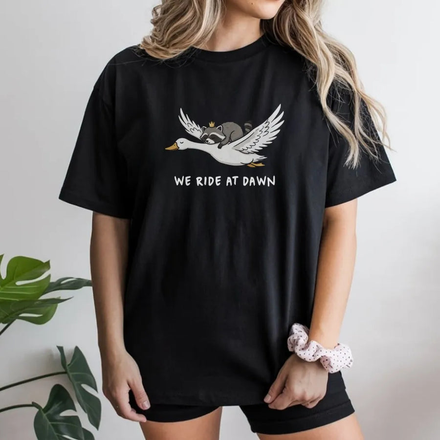 We Ride At Dawn Raccoon Goose T-Shirt | Funny Animal Graphic Print | Premium Soft Cotton Unisex Tee | Cute Critter Gift for Men and Women