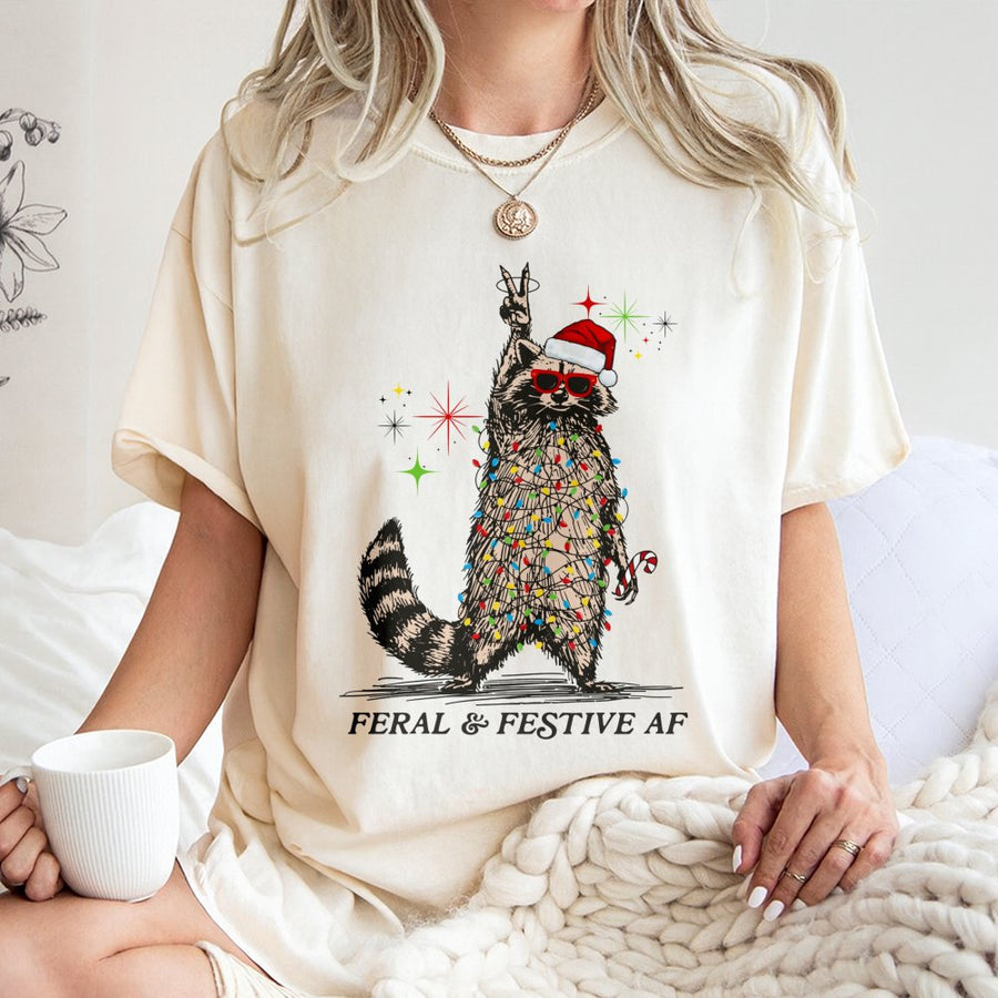 Feral and Festive AF Raccoon T-Shirt | Funny Tangled Christmas Lights Graphic | Premium Cotton Unisex Tee | Unique Ugly Christmas Party Gift