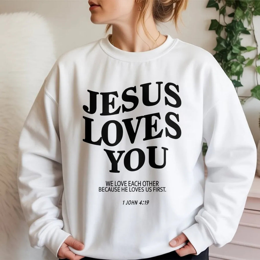 Jesus Loves You Sweatshirt | 1 John 4:19 Bible Verse Typography | Premium Cotton Blend | Christian Faith Gift for Men and Women