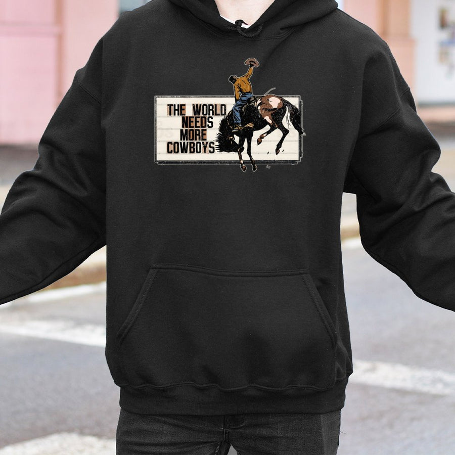 The World Needs More Cowboys Hoodie | Vintage Rodeo Graphic Western Sweatshirt | Premium Cotton Blend | Gift for Country Music Lovers & Ranchers