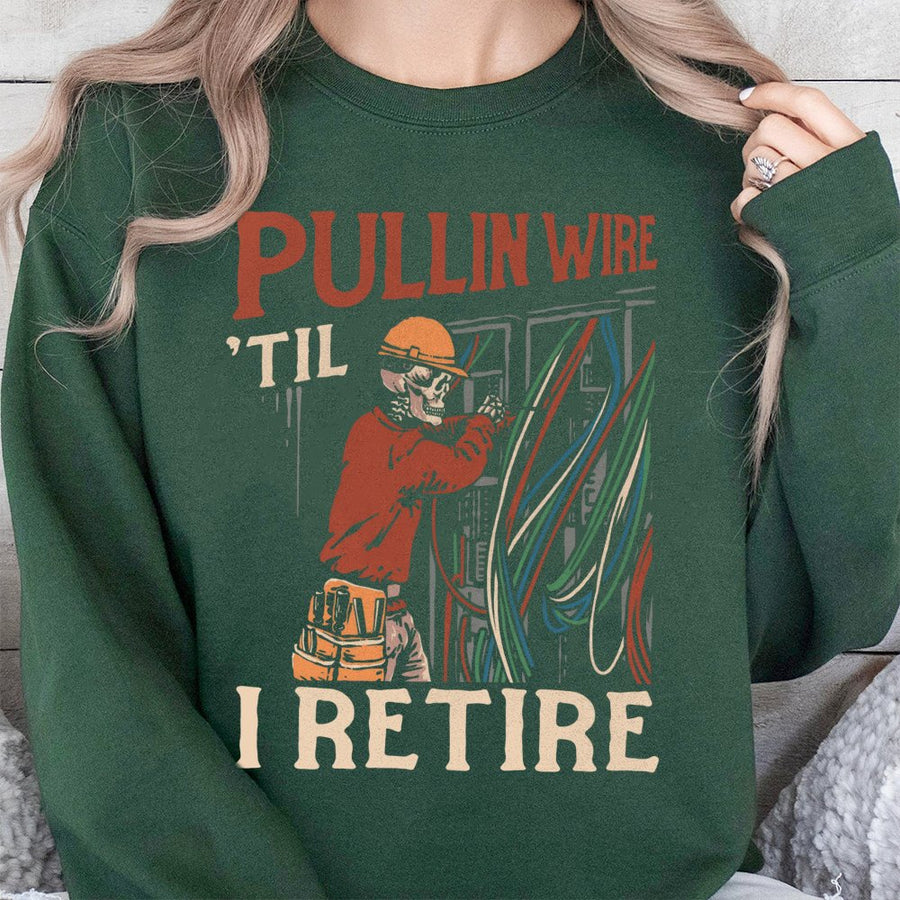 Electrician Sweatshirt | Pullin Wire 'Til I Retire Skeleton Graphic | Premium Cotton Blend Crewneck | Funny Blue Collar Gift For Journeyman Lineman