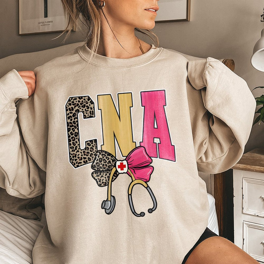 CNA Sweatshirt | Leopard Print Nursing Assistant Graphic with Bow and Stethoscope | Cotton Polyester Blend | Nursing School Gift for CNA Graduation