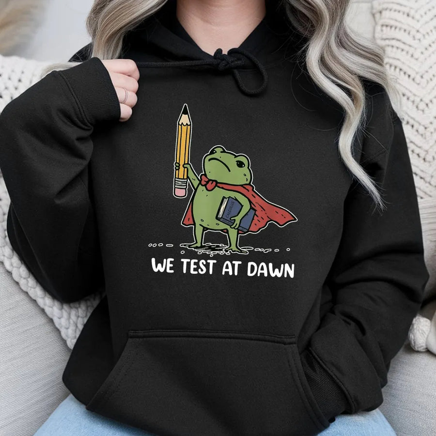 Funny Teacher Hoodie | We Test at Dawn Superhero Frog Graphic | Soft Cotton Blend Pullover | Gift for Educators and Professors