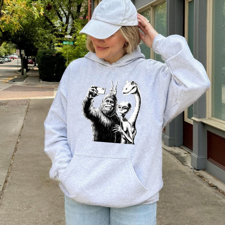 Bigfoot Alien Selfie Hoodie | Funny Cryptid Dinosaur Graphic | Premium Cotton Blend Pullover | Unique Gift For Sci-Fi Lovers