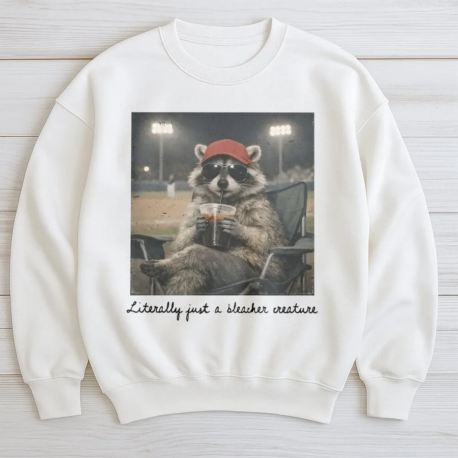 Bleacher Creature Sweatshirt | Funny Raccoon Baseball Graphic | Cozy Unisex Crewneck | Gift for Baseball Mom, Softball Fan Gift