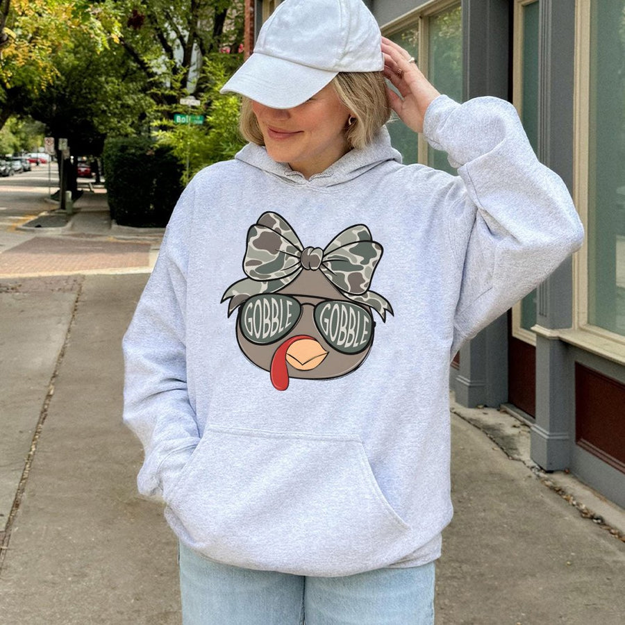 Thanksgiving Turkey Hoodie | Camo Coquette Bow Graphic Design | Premium Cotton-Blend | Festive Turkey Day Gift For Women And Men