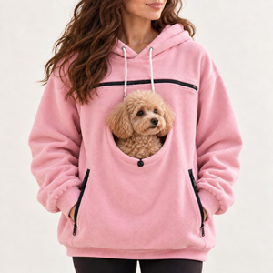 Pink pet carrier hoodie, dog looking out of the pouch opening, close view