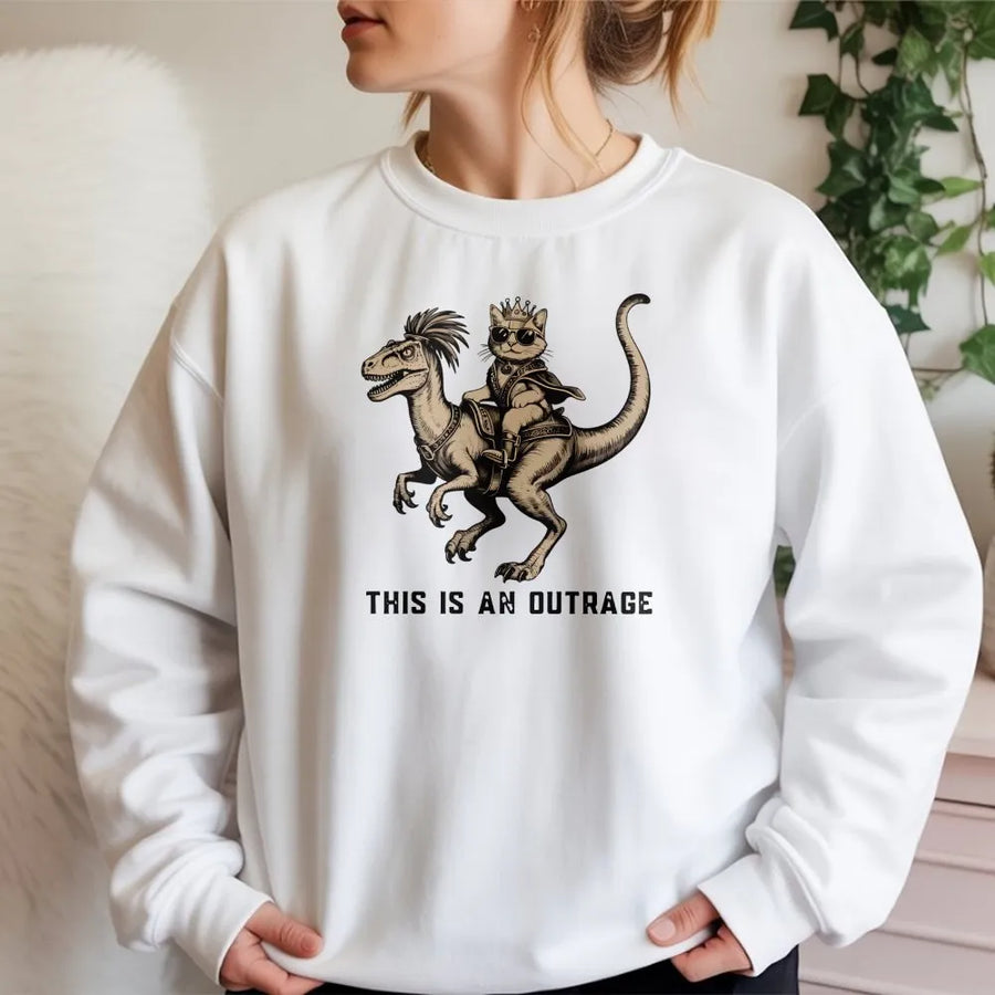Funny Cat Riding Dinosaur Sweatshirt | This Is An Outrage Graphic Print | Premium Cotton Blend Crewneck | Fantasy Book Lover Gift For Readers
