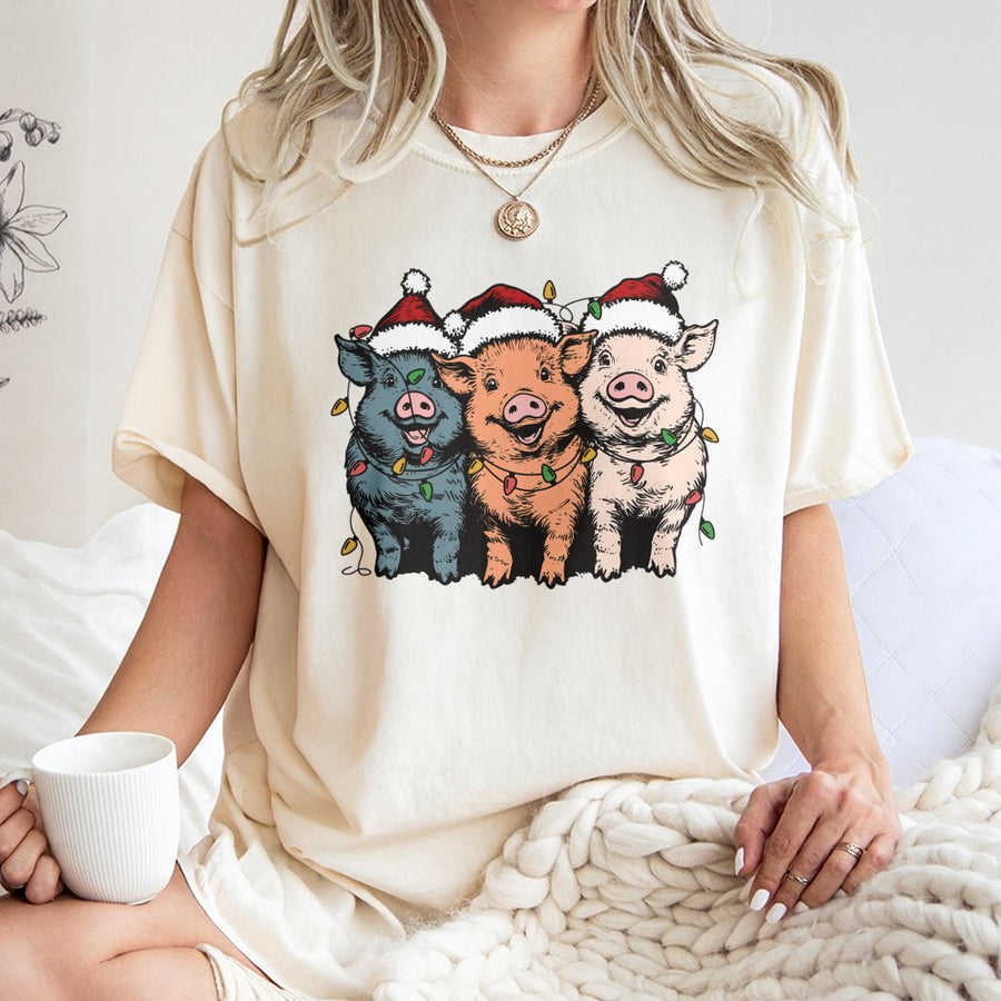 Christmas Pigs T-Shirt | Funny Farm Animals in Santa Hats with Holiday Lights | 100% Cotton Premium Tee | Unique Gift for Pig Lovers & Farmers