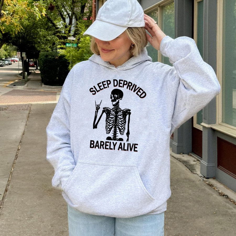 Sleep Deprived Barely Alive Hoodie | Skeleton Rock Hand Graphic | Soft Cotton-Polyester Blend | Funny Sarcastic Gift for Tired Students and Moms