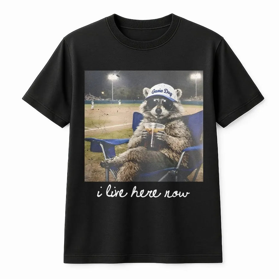 I Live Here Now Raccoon Shirt | Funny Travel Ball Parent Life Meme | Soft 100% Cotton Tee | Gift for Baseball Mom or Softball Dad