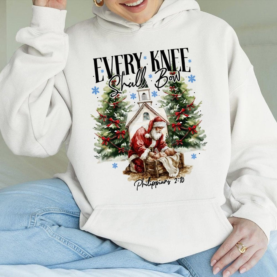 Every Knee Shall Bow Hoodie | Santa Kneeling Before Baby Jesus Religious Christmas Graphic | Premium Cotton Blend | Christian Holiday Gift for Believers