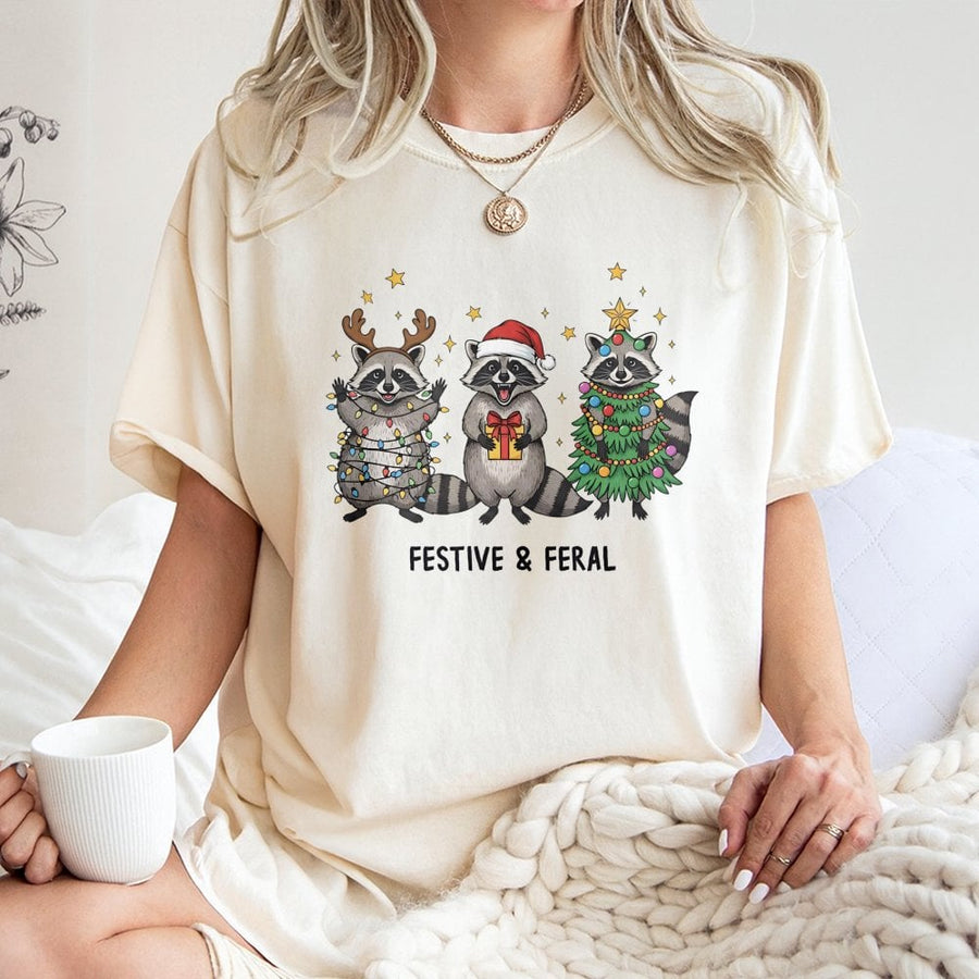 Festive and Feral Raccoon T-Shirt | Funny Christmas Animal Graphic | Soft 100% Cotton Premium Tee | Unique Holiday Gift for Men and Women